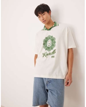 ASOS DESIGN oversized polo med stadstryck i off-white