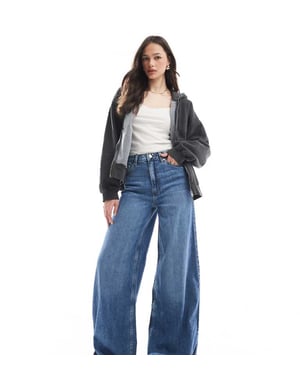 ASOS DESIGN Lång mjuk palazzo-jeans i medtvättad blå