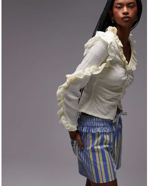 LAAGAM textured ruffle front button up blouse in white