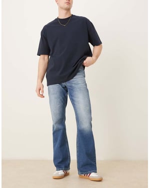 ASOS DESIGN vintage flare jeans i medtvättad blå