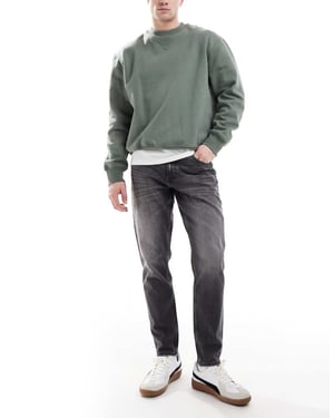ASOS DESIGN stretch taperade jeans i vintage svart tvätt