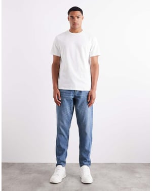 ASOS DESIGN tapered jeans i medelblå tvätt