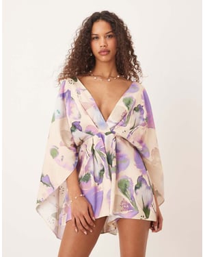ASOS DESIGN playsuit med djup urringning och överdrivna ärmar i abstrakt blommönster