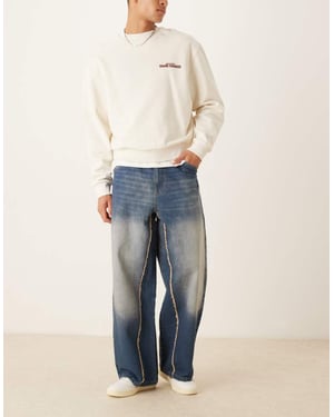 ASOS DESIGN super baggy jeans med rå kant i tvättad indigo