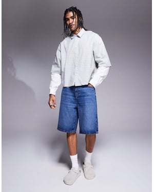 ASOS DESIGN längre längd denimjorts i medelblå ttvätt