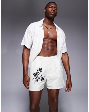 ASOS DESIGN korta badshorts med blommönster i krämfärg