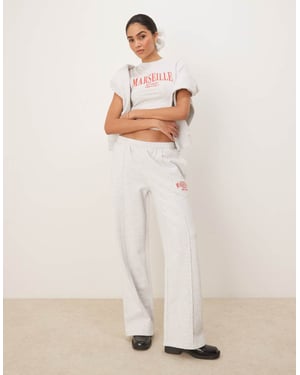 ASOS DESIGN rak ben jogger med Marseille broderad grafik i isgrå