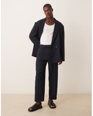 ASOS DESIGN storskaliga tapered kostymbyxor i marinblå randigt