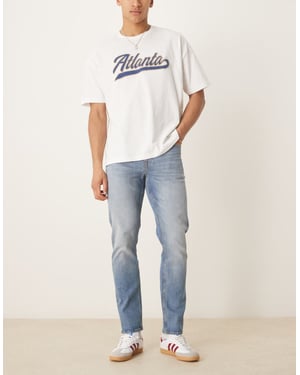 ASOS DESIGN slim fit jeans i vintage medelblå tvätt