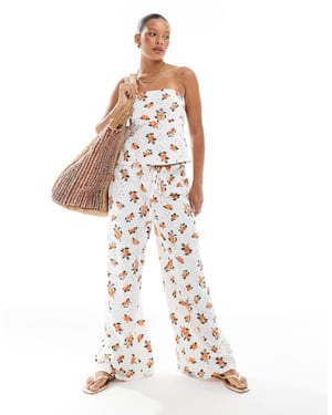 ASOS DESIGN broderad pyjamasbyxa med knytmidja i vitt och orange mönster