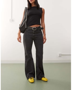 Weekday Helix låg midja vida flare jeans i sliten svart tvätt