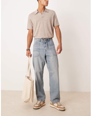 ASOS DESIGN baggy jeans med dragkedja i ljus tvättad blå med nyans