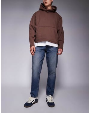 ASOS DESIGN tapered fit jeans i mörk tvättblå