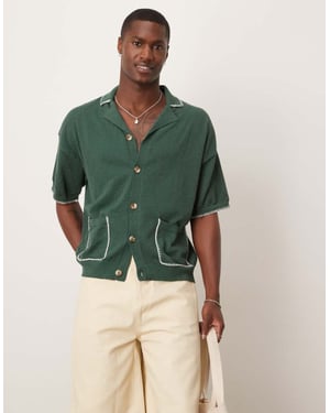 ASOS DESIGN avslappnad boxy passform stickad knapp-up polo med filtstygn i mörkgrön