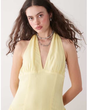 Reclaimed Vintage halter playsuit with ruffle shorts in yellow