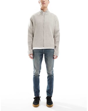 ASOS DESIGN skinny jeans with green tint in light wash blue