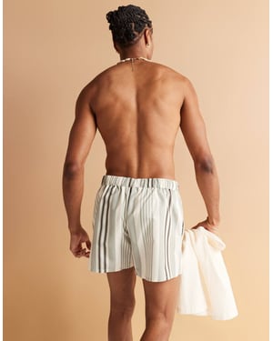 ASOS DESIGN swim shorts in short length in cream stripe with placement print