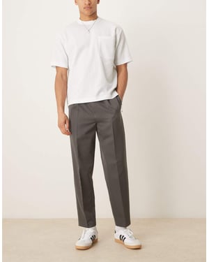 ASOS DESIGN smart relaxed tapered trousers with front pleat in charcoal
