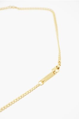 Halsband med metalldekoration och tändarfodral i guld