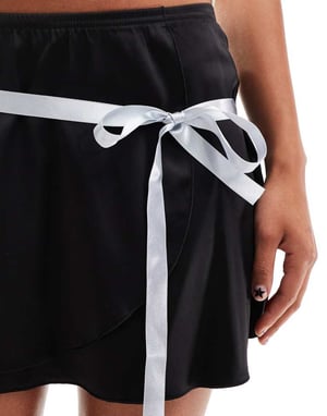 Daisy Street mini flippy skirt in black stretch satin with blue ribbon detail