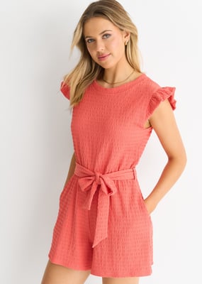 Koralröd stretchig playsuit med volanger och elastisk midja