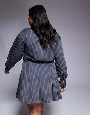 In The Style Plus x Natalya Wright exclusive tailored pleated mini shirt dress in charcoal pinstripe