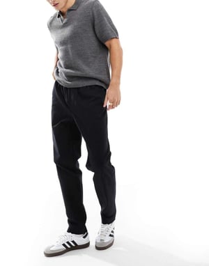 ASOS DESIGN tapered pull on trousers in black with patch