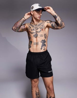 ASOS DESIGN swim shorts in mid length with embroidery placement in black