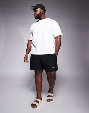 ASOS DESIGN swim shorts in mid length with embroidery placement in black