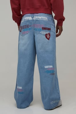 Caution All Over Graphic Tinted Baggy Fit Jeans