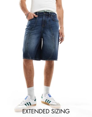 ASOS DESIGN lång denimshorts med paneler i mellanblå