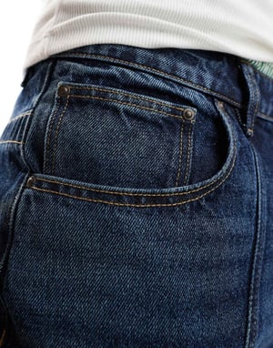 ASOS DESIGN lång denimshorts med paneler i mellanblå
