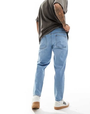 ASOS DESIGN tapered fit jeans in light wash blue
