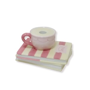 House Vitamin Candle holder cup on pile of books yellow/pink dolomite 16,5x13,5x9,5cm