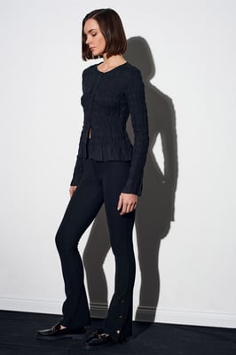 Hoog-getailleerde flare leggings met knoopdetail
