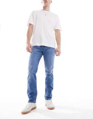 Wrangler Larston slim tapered fit jeans in mid wash blue