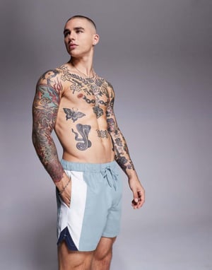 ASOS DESIGN swim shorts in short length with side vent cut and sew in blue