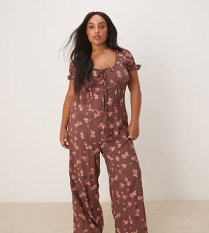 ASOS DESIGN Curve spun lace trim corset waist jumpsuit in mauve floral print