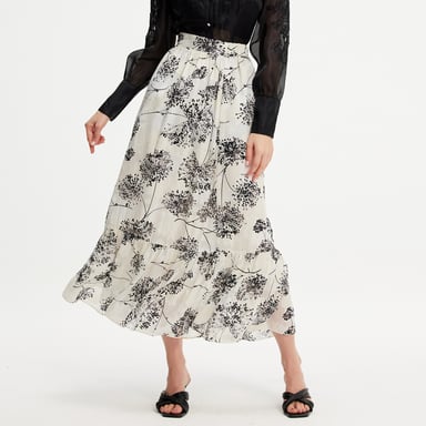 Long skirt with linear print and ruffles