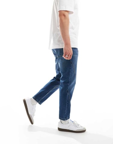 ASOS DESIGN tapered fit jeans with panelling detail in mid wash blue
