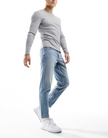 ASOS DESIGN tapered fit jeans in light blue wash