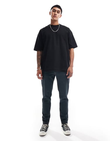ASOS DESIGN tapered fit jeans in washed grey with green tint