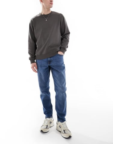 ASOS DESIGN stretch tapered jeans in mid wash
