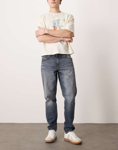 ASOS DESIGN stretch tapered jeans in mid wash blue