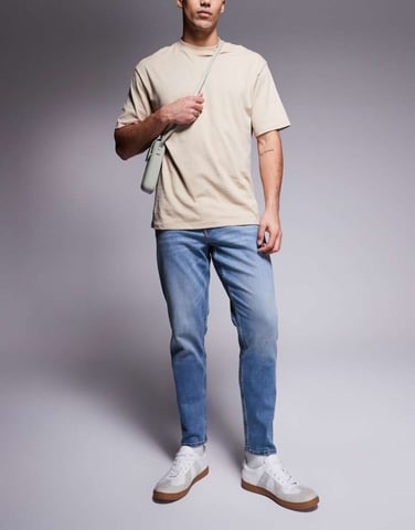 ASOS DSIGN stretch tapered jeans in mid wash with vintage tint