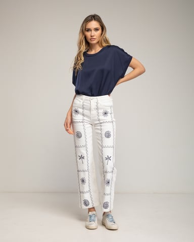 Straight-cut denim trousers with geometric patterns, snails and palm trees