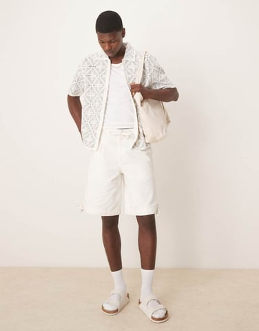 ASOS DESIGN longer length shorts with pleat detailing in ecru