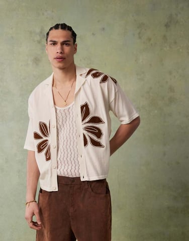 ASOS DESIGN relaxed knitted button through polo with floral embroidery in ecru