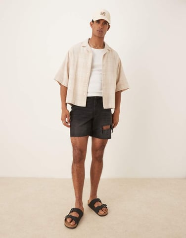 ASOS DESIGN mid length slim denim shorts with rips in black