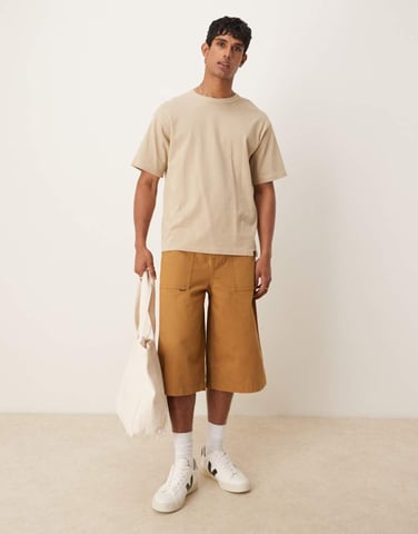 ASOS DESIGN longer length shorts with embroidered back pockets in tan